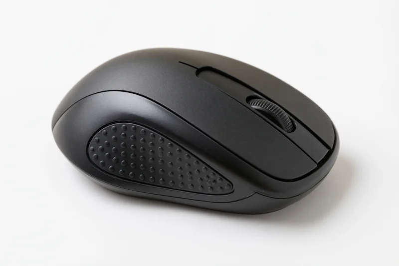 Black wireless computer mouse on plain white surface