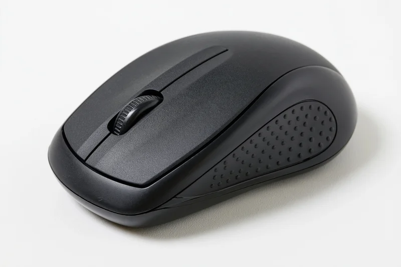 Black wireless computer mouse on plain white surface