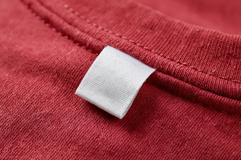 White care label sewn into red garment collar