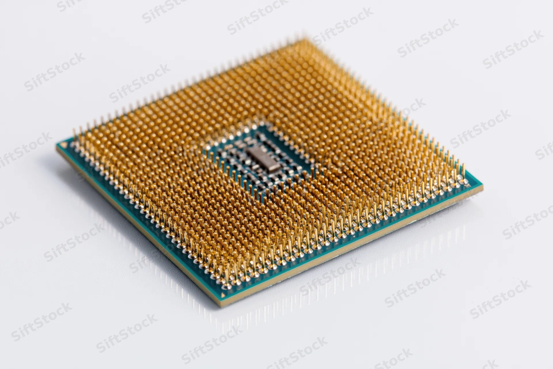 Cpu processor chip with gold pins viewed from below on white background