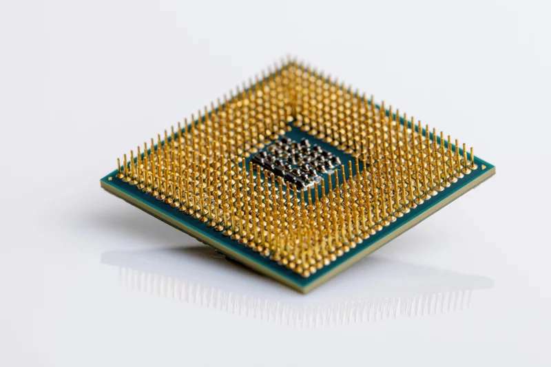Cpu processor chip with gold pins on white background