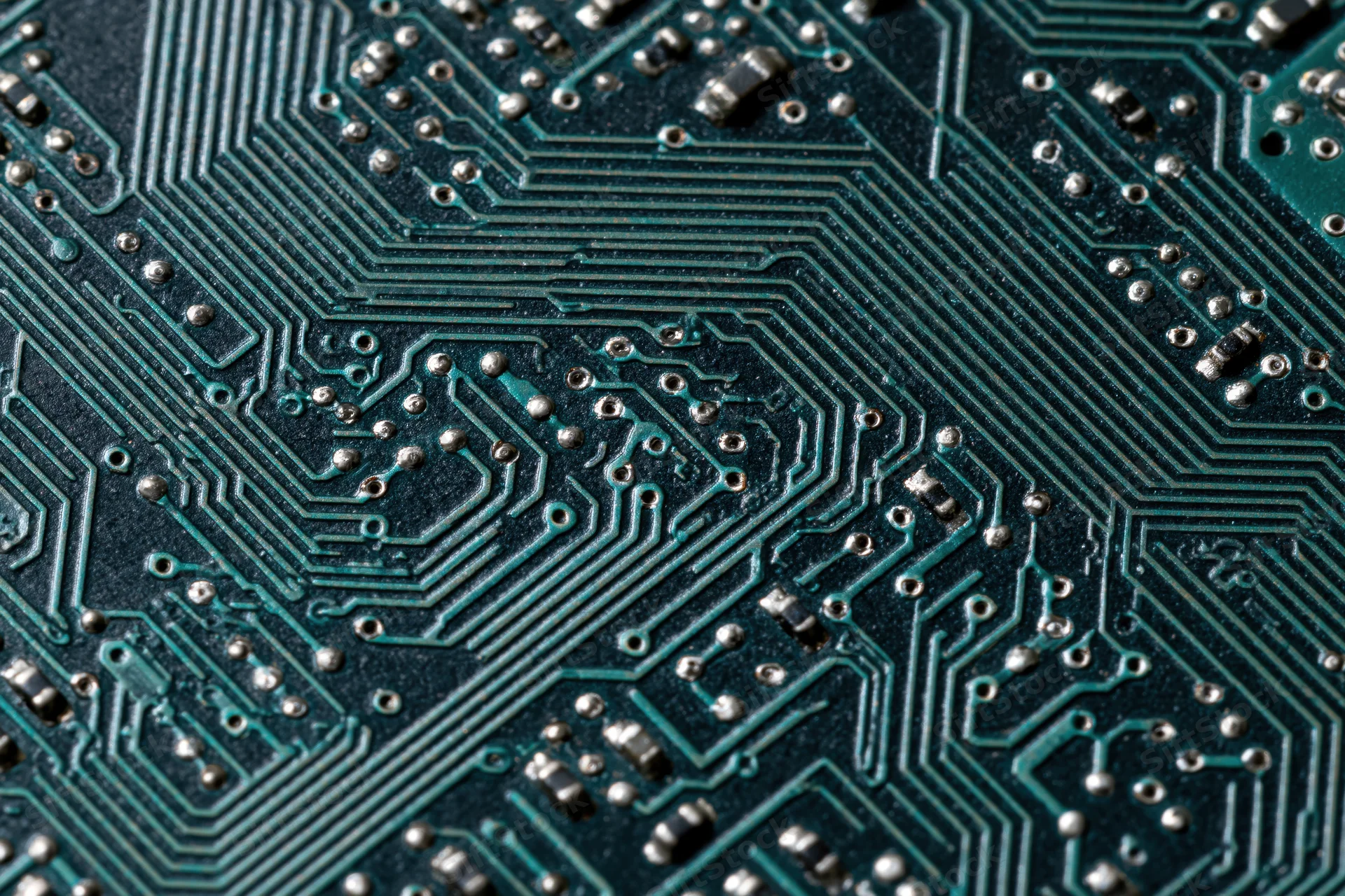 Close-up of a computer circuit board showing intricate pathways and soldered components