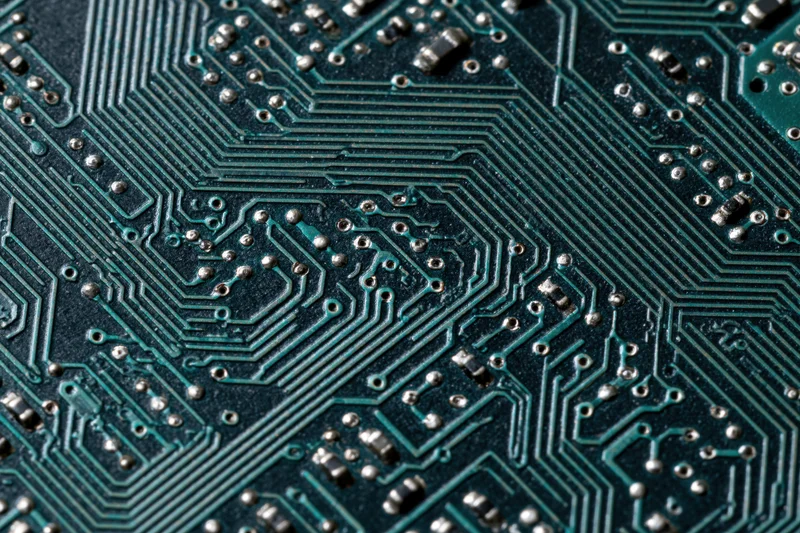 Close-up of a computer circuit board showing intricate pathways and soldered components