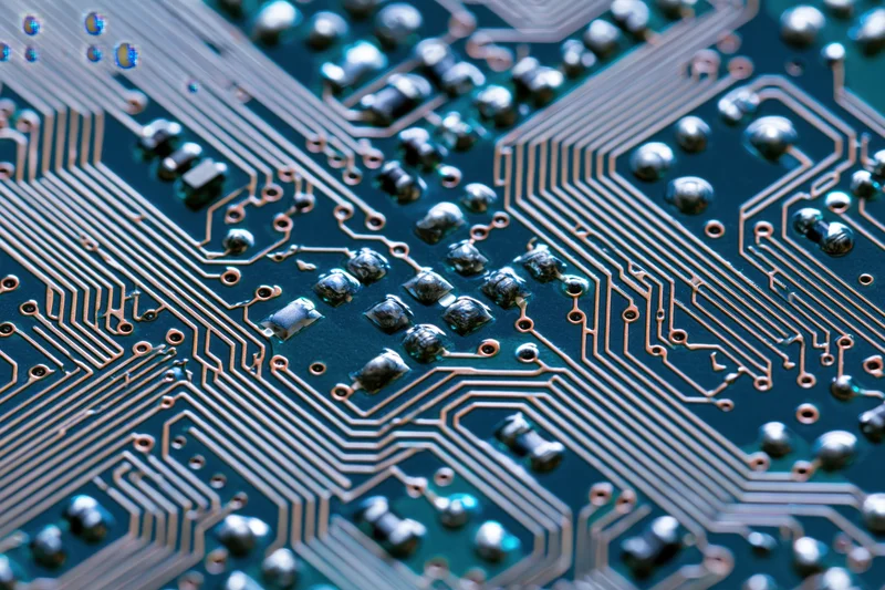 Close-up of a circuit board surface showing copper traces and soldered components