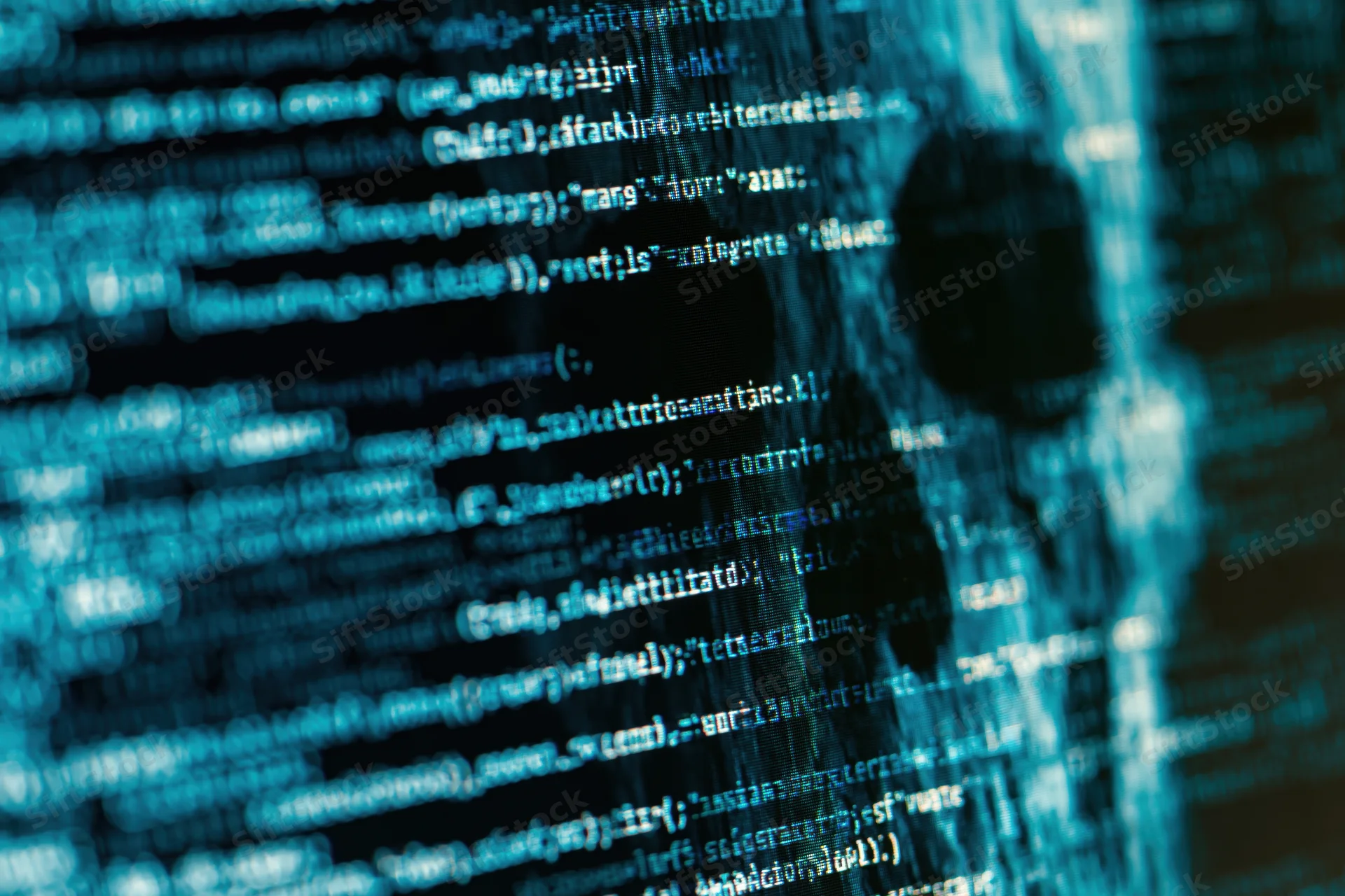 Glowing lines of code on a dark computer screen closeup