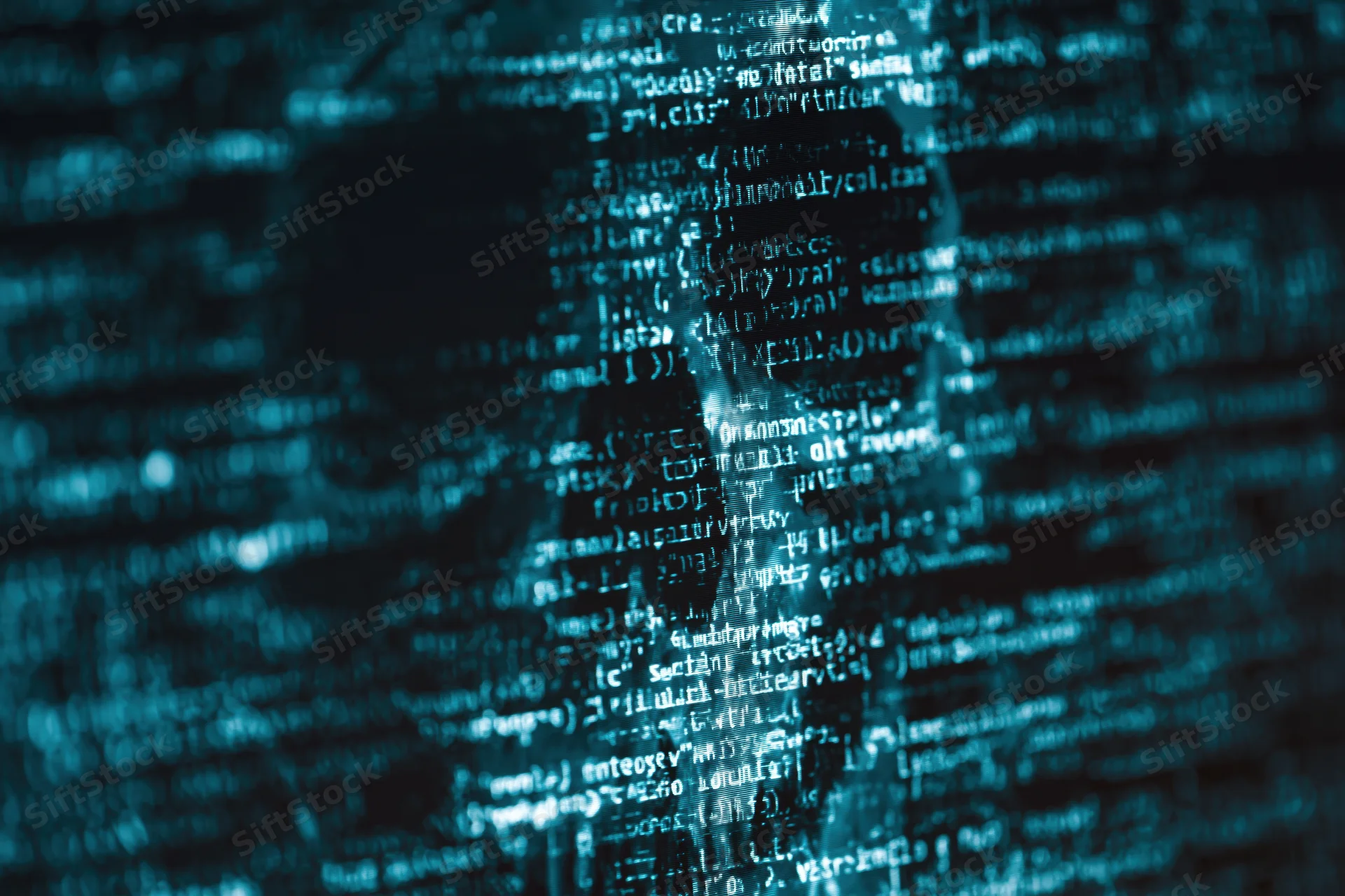Glowing lines of code on a dark computer screen with blurred background