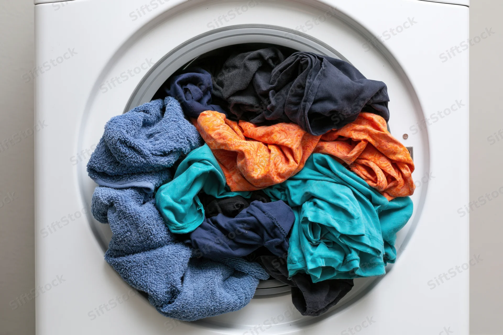 Clothes loaded into front-loading washing machine drum
