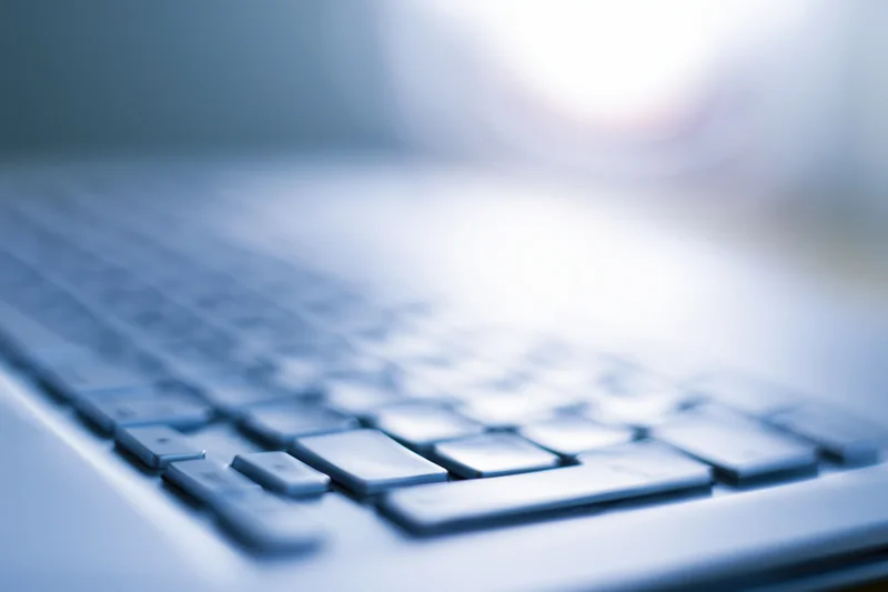 Close-up of laptop keyboard with shallow depth of field and blurred background