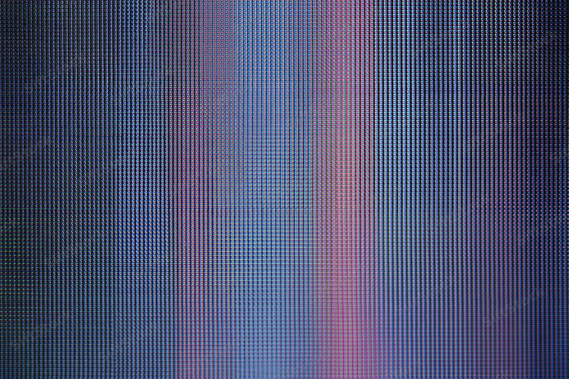 Extreme close-up of lcd screen surface showing pixel grid and color gradient