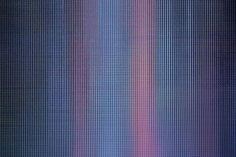 Extreme close-up of lcd screen surface showing pixel grid and color gradient