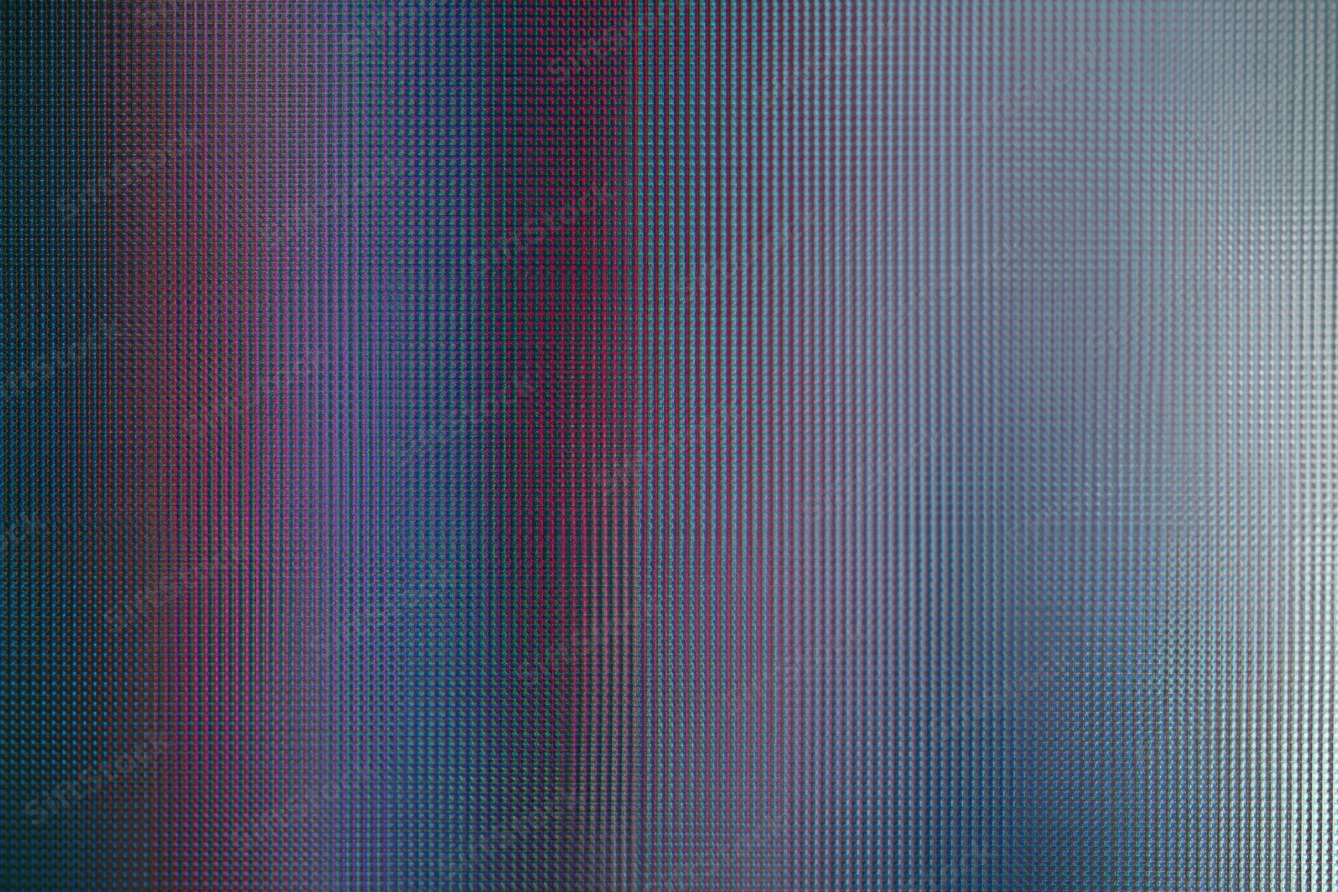 Extreme close-up of an lcd screen surface showing pixel grid and color variation