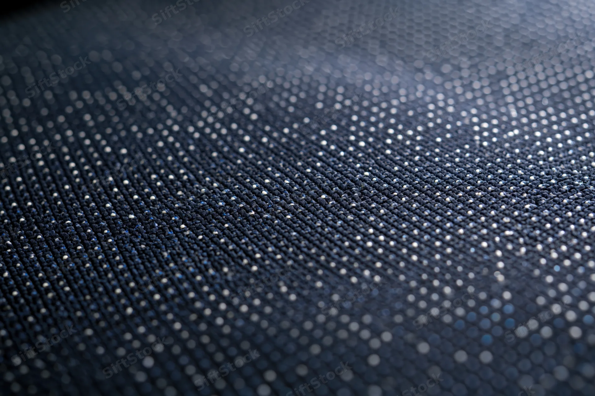 Close-up of led display panel surface showing pixel grid and light dots