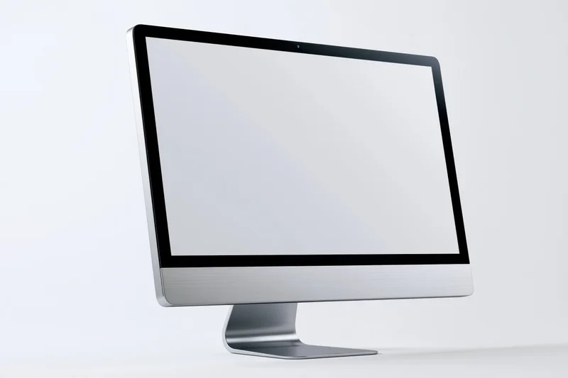 Modern all-in-one desktop computer monitor with blank white screen on white background