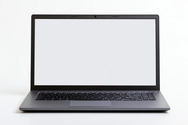 Open dark aluminum laptop with blank white screen on white background