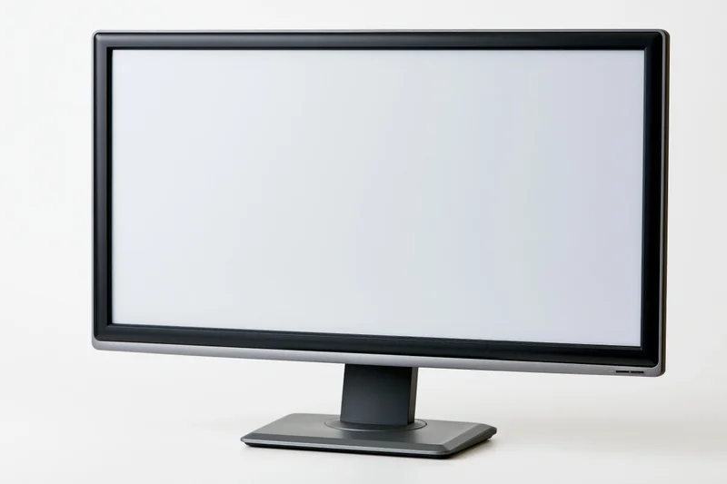 Modern flat-screen computer monitor with blank white screen on white background