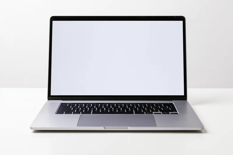 Modern slim laptop with blank white screen open centered front view on white surface