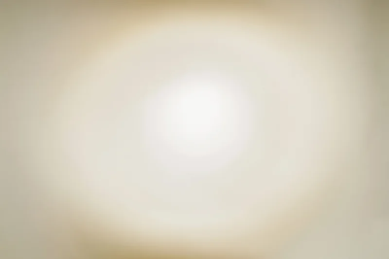 Soft radial vignette on off-white background with central glow and even gradient