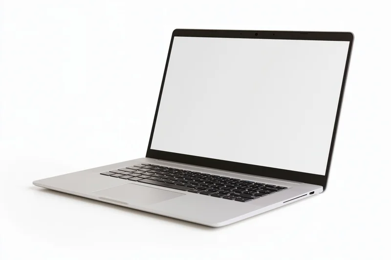 Silver aluminum laptop open at an angle with blank white screen on white background