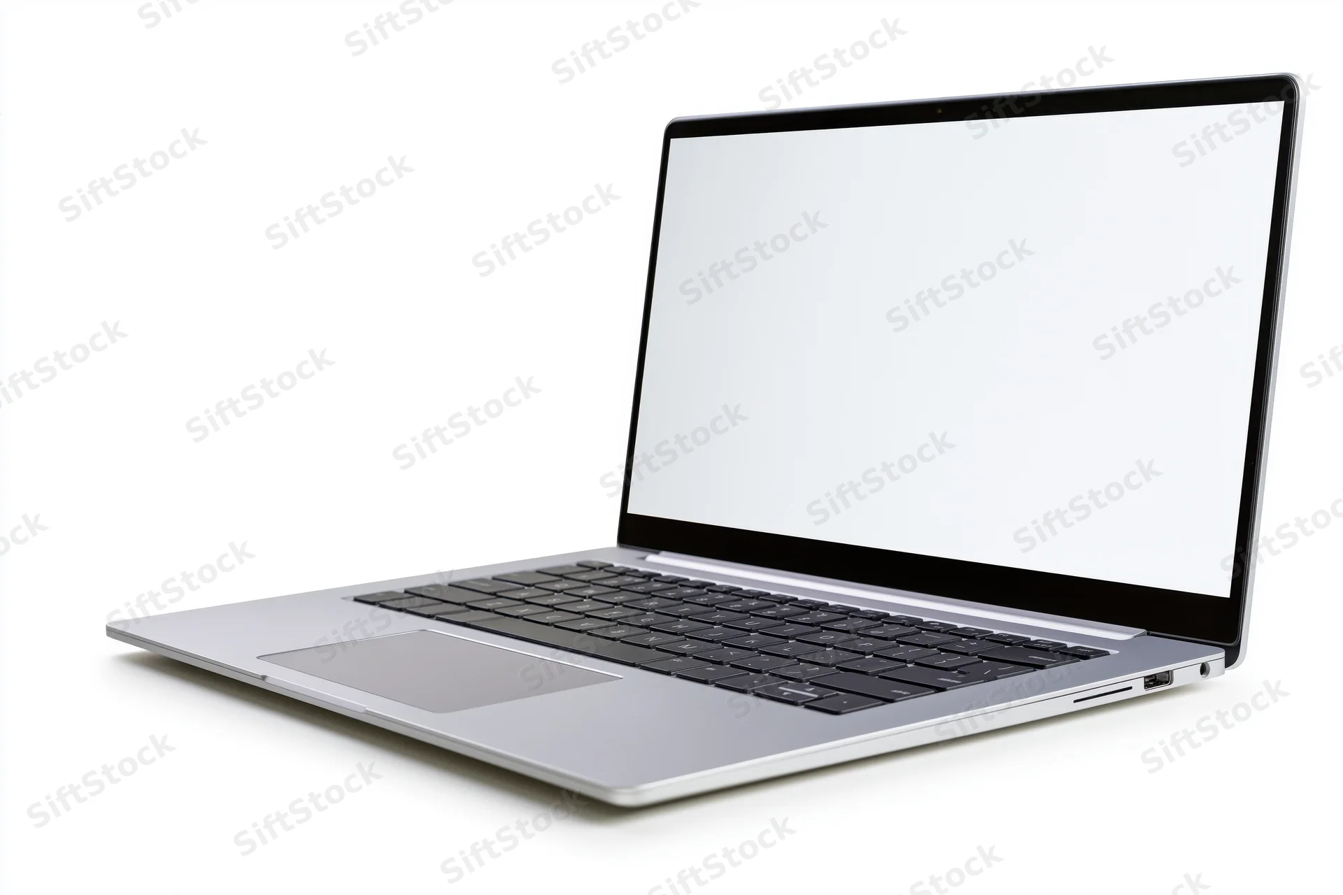Silver aluminum laptop open at an angle with blank white screen on white background