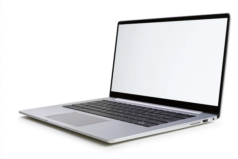 Silver aluminum laptop open at an angle with blank white screen on white background