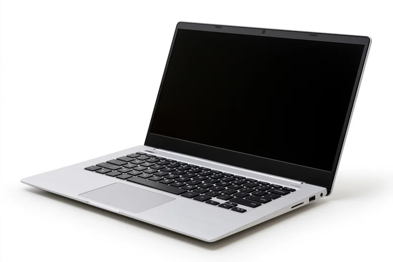 Silver aluminum laptop open with blank black screen on white background