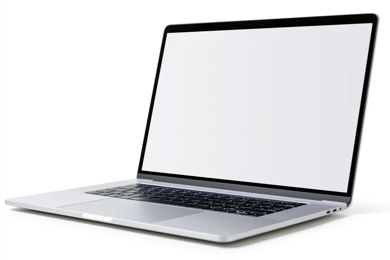 Silver aluminum laptop open with blank white screen on white background