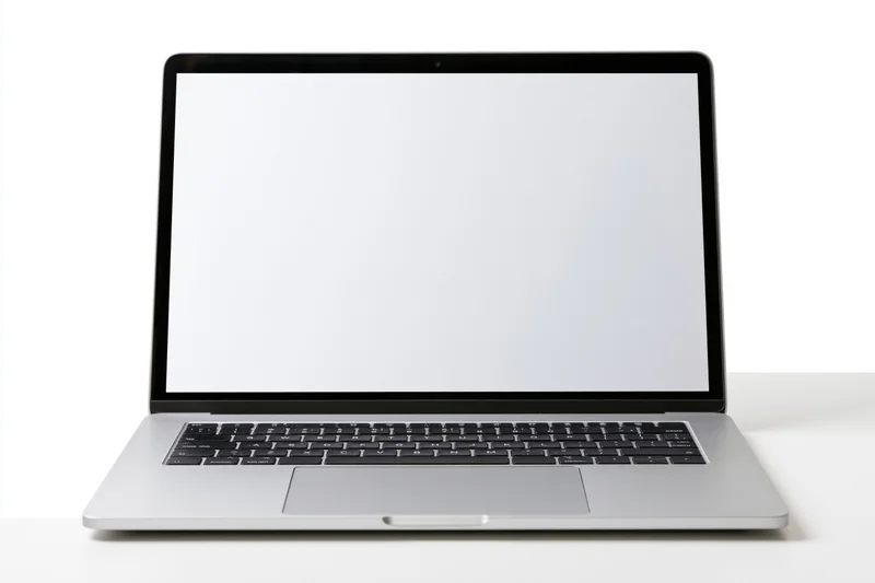 Silver aluminum laptop open with blank white screen on white surface