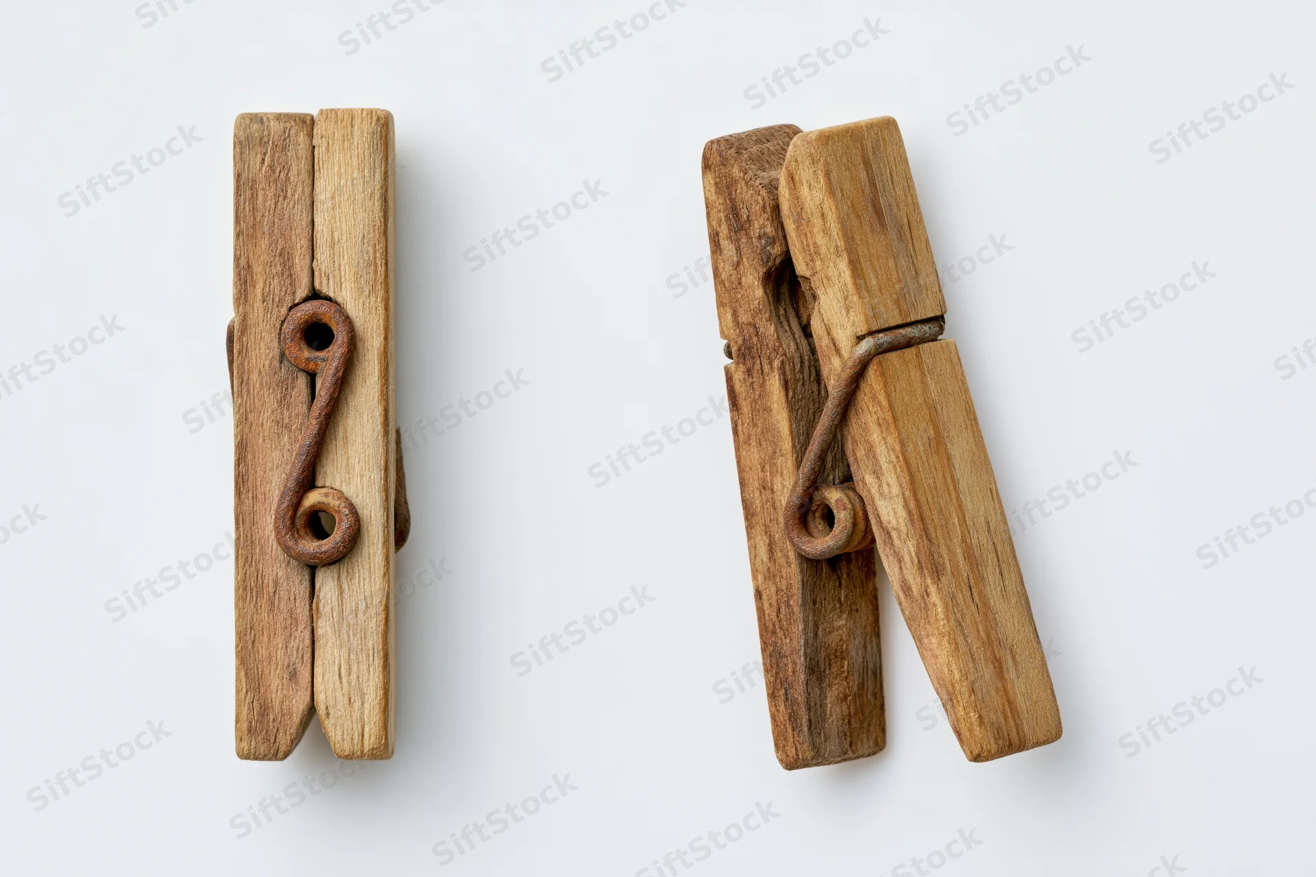 Two views of an aged wooden clothespin with metal spring on white background