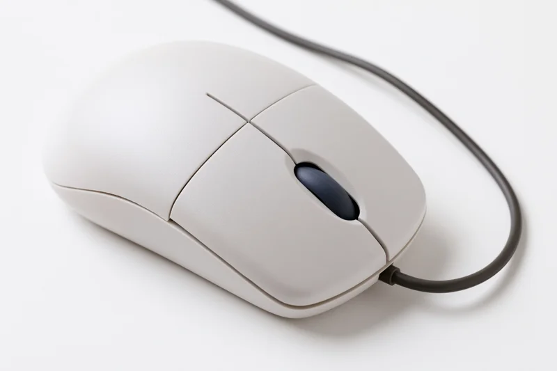 White wired computer mouse with dark blue scroll wheel on plain white surface