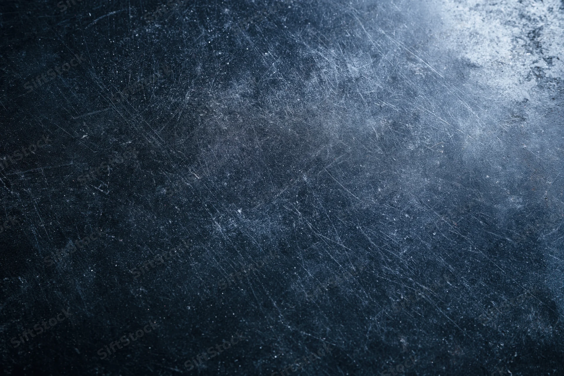 Dark scratched metal surface with grunge texture and blue-gray tones