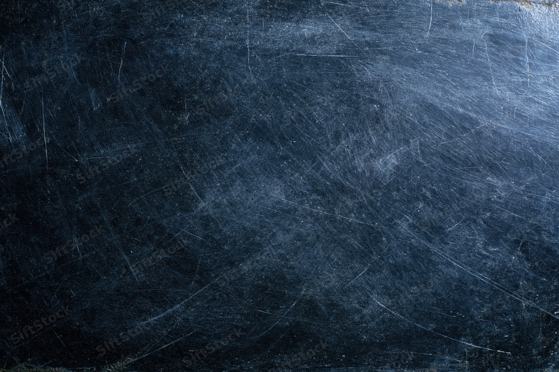 Dark scratched metal surface with worn texture and fine scratches across the frame