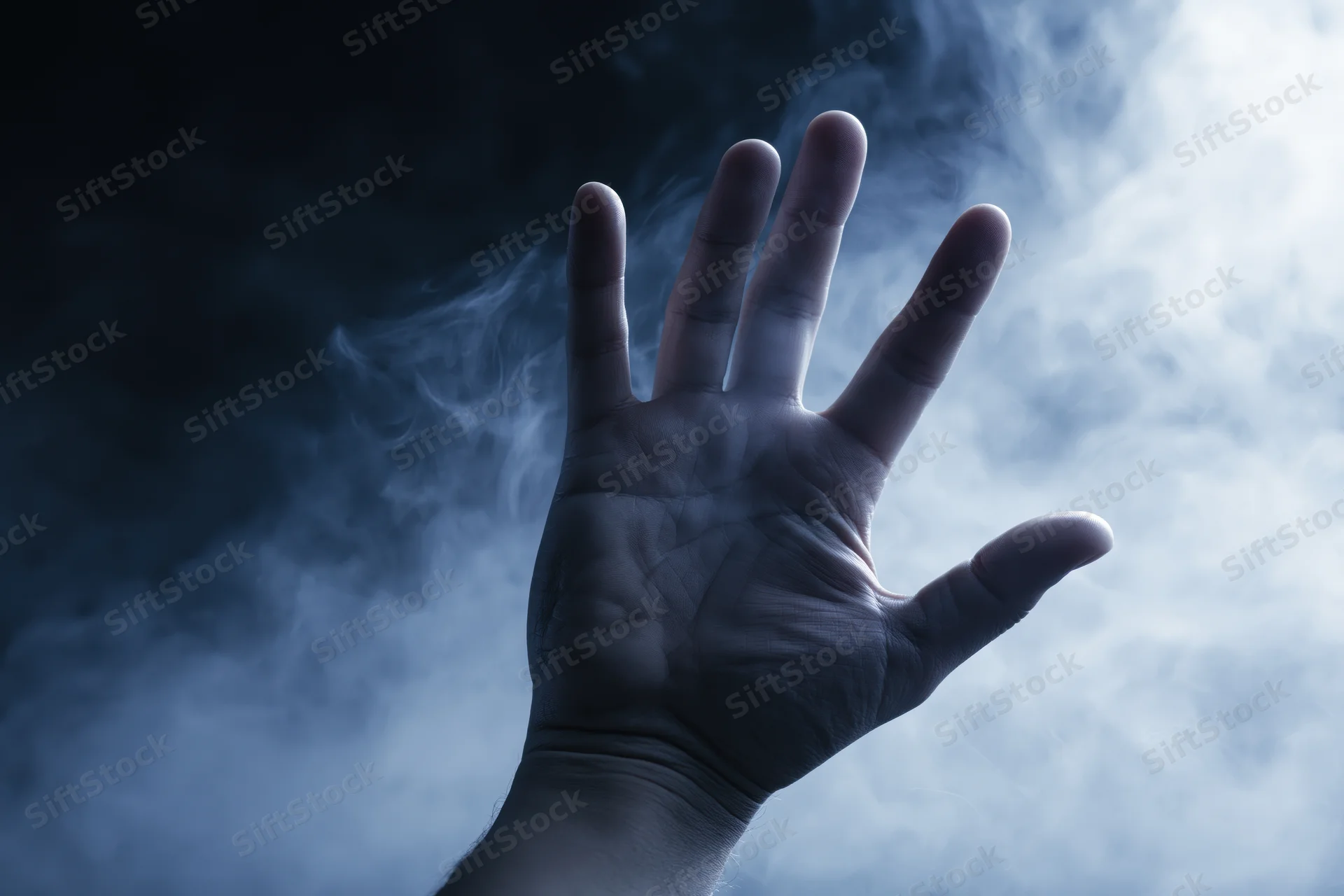 A hand reaching forward with splayed fingers through swirling smoke in a dark blue atmosphere