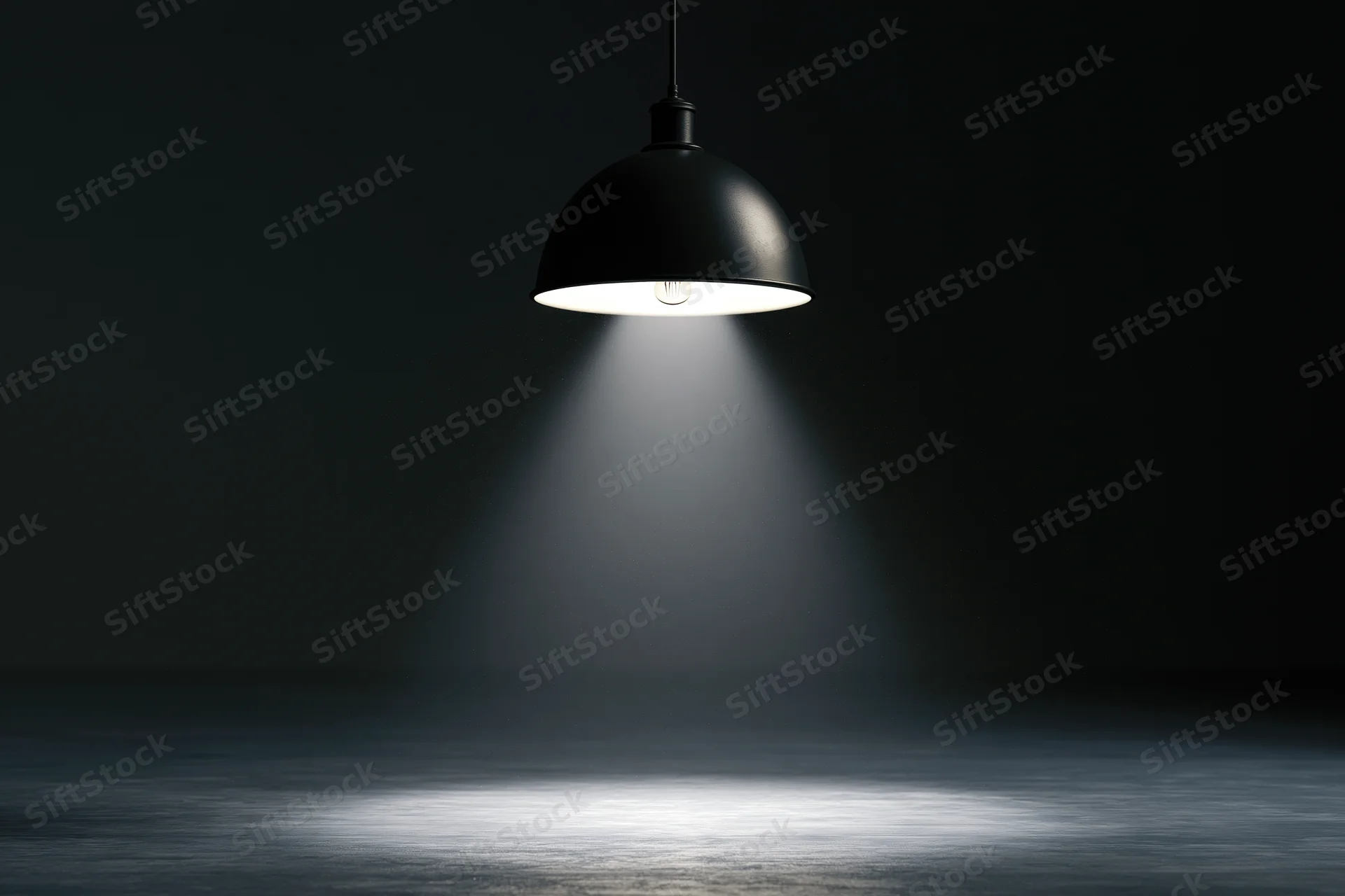 Black dome pendant lamp hanging from ceiling casting spotlight on dark floor