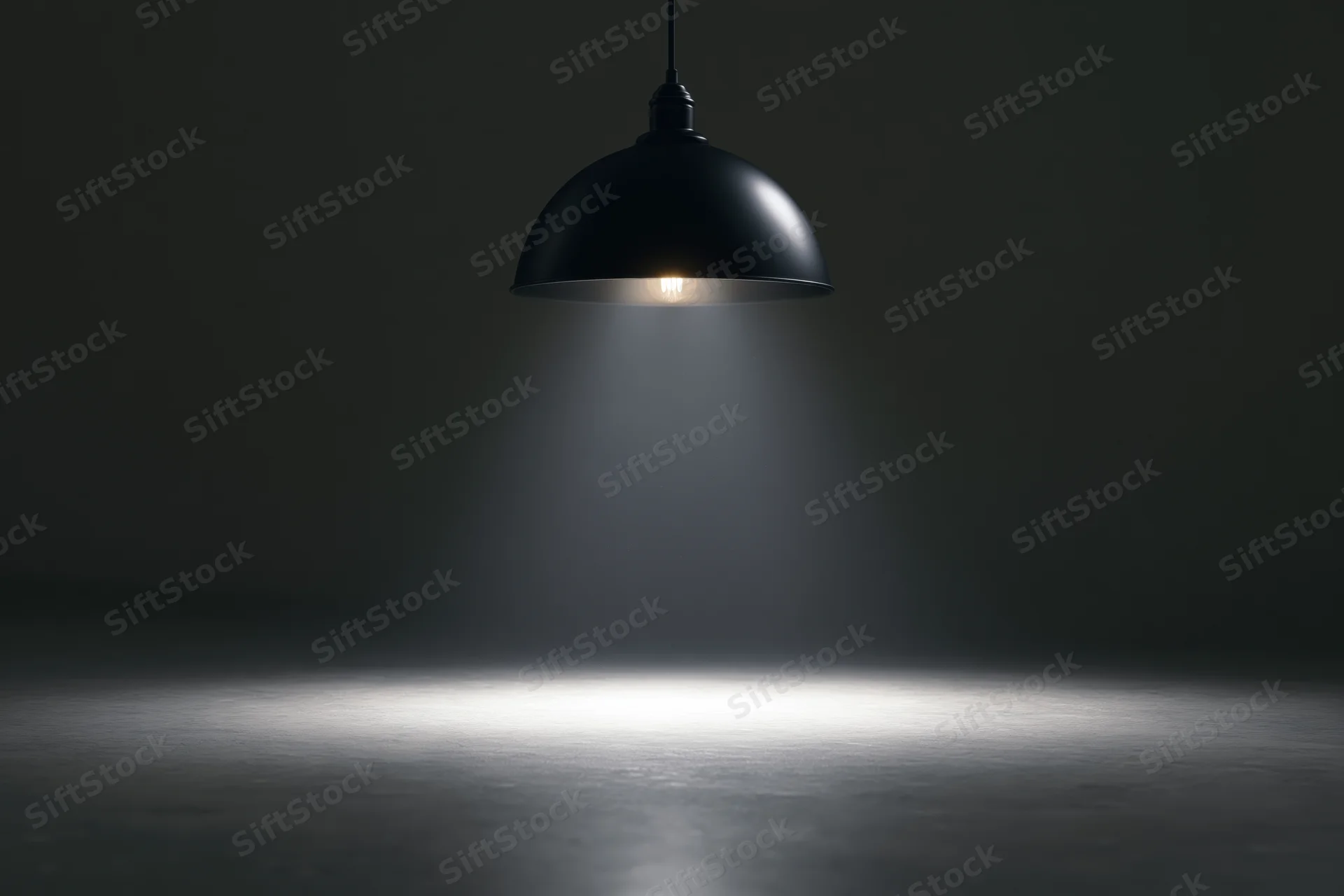 Black dome pendant lamp hanging from ceiling casting spotlight on dark floor