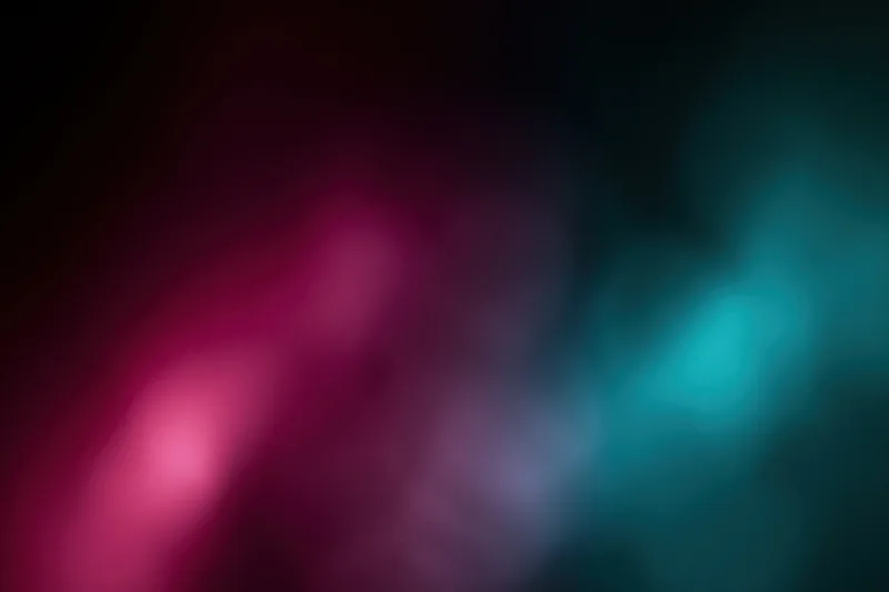 Abstract blurred light gradient in magenta and teal on dark background