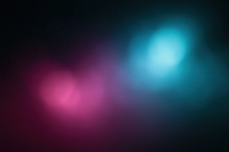 Abstract blurred light gradient on dark background with pink and blue hues