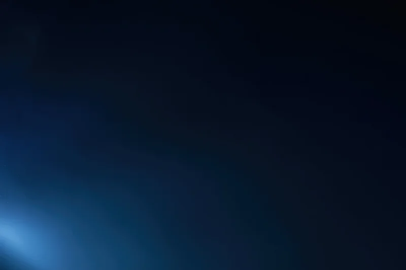 Smooth navy blue gradient background with soft light glow in the corner