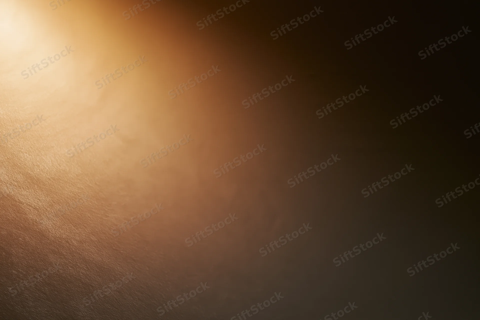 Warm spotlight glowing softly on a smooth textured surface with gradient background
