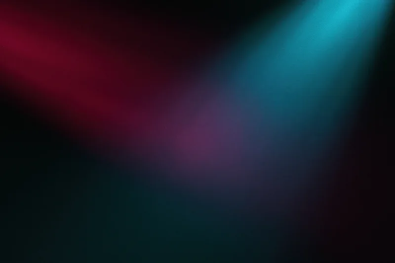 Abstract stage lighting beams in red and blue blending on a dark wall