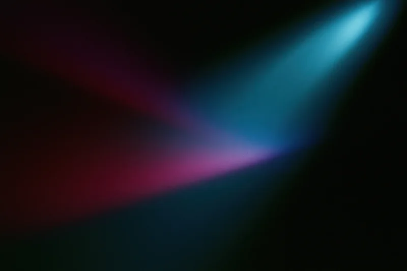 Blue and red stage lights overlapping on a dark wall, creating a colorful gradient effect