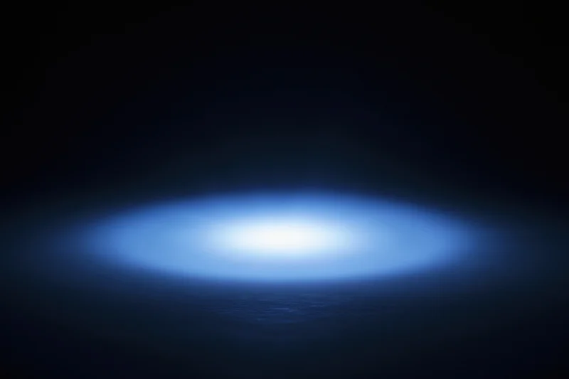 Soft blue radial light glow centered on dark studio backdrop