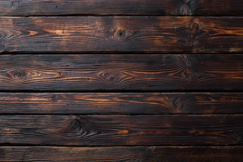 Dark aged wooden planks arranged horizontally as a textured surface