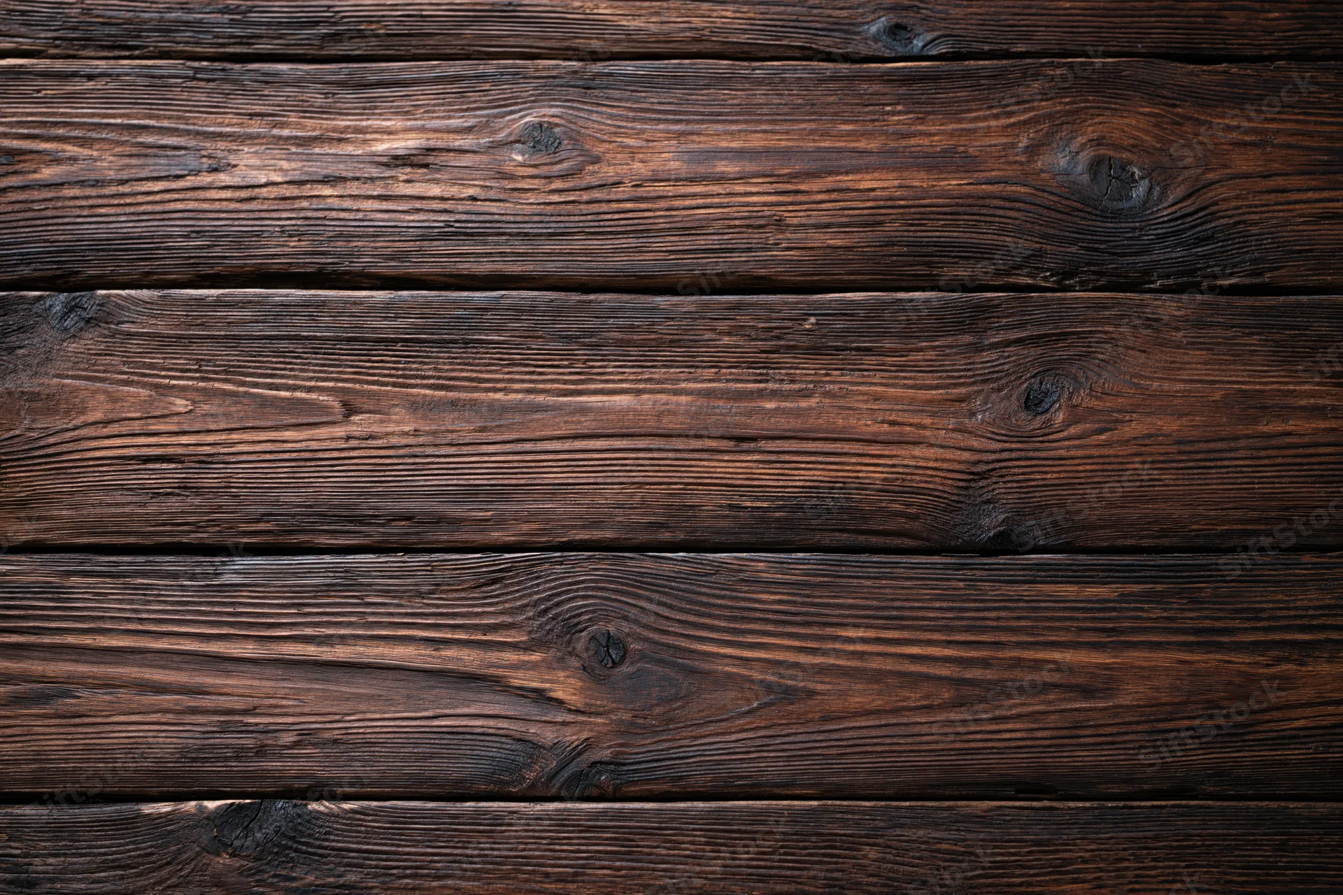 Dark aged wooden planks arranged horizontally as a textured flat lay surface