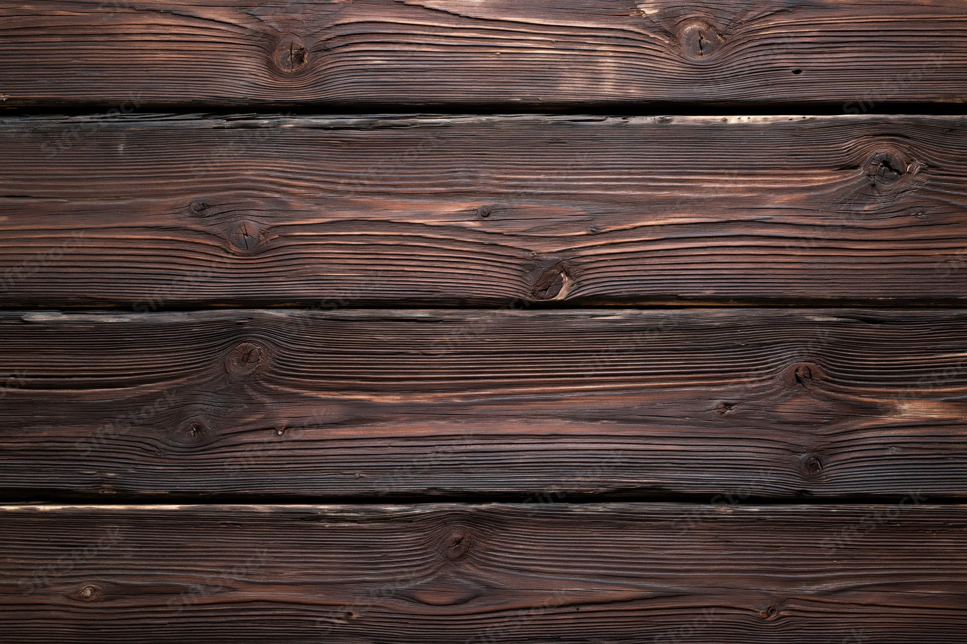Horizontal dark aged wooden planks forming a flat surface with visible grain and knots