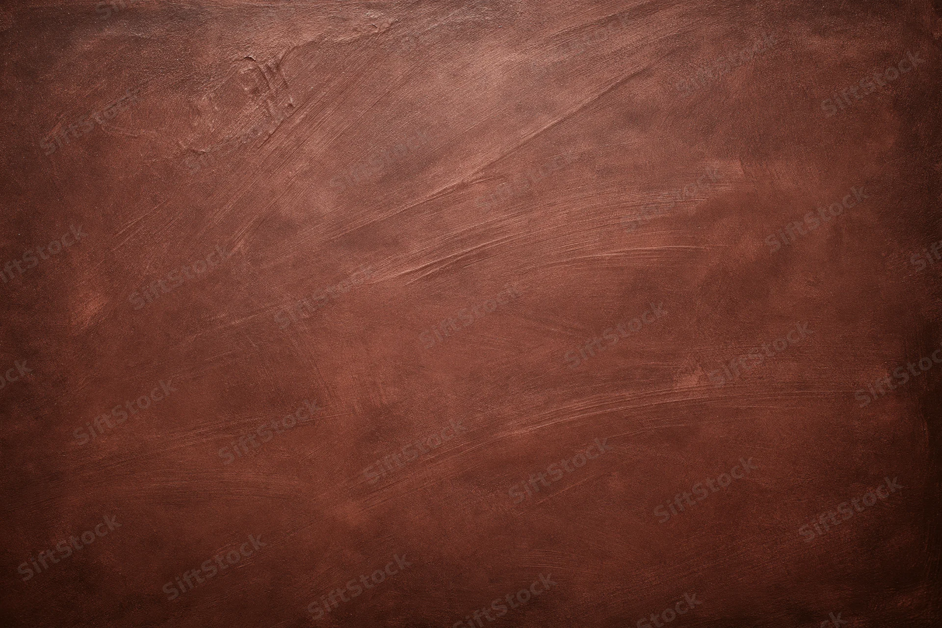 Aged plaster wall surface with rough texture and warm brown tones filling the frame