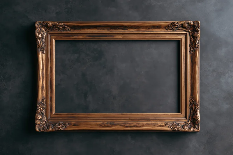 Ornate wooden picture frame with carved details hanging on dark textured wall
