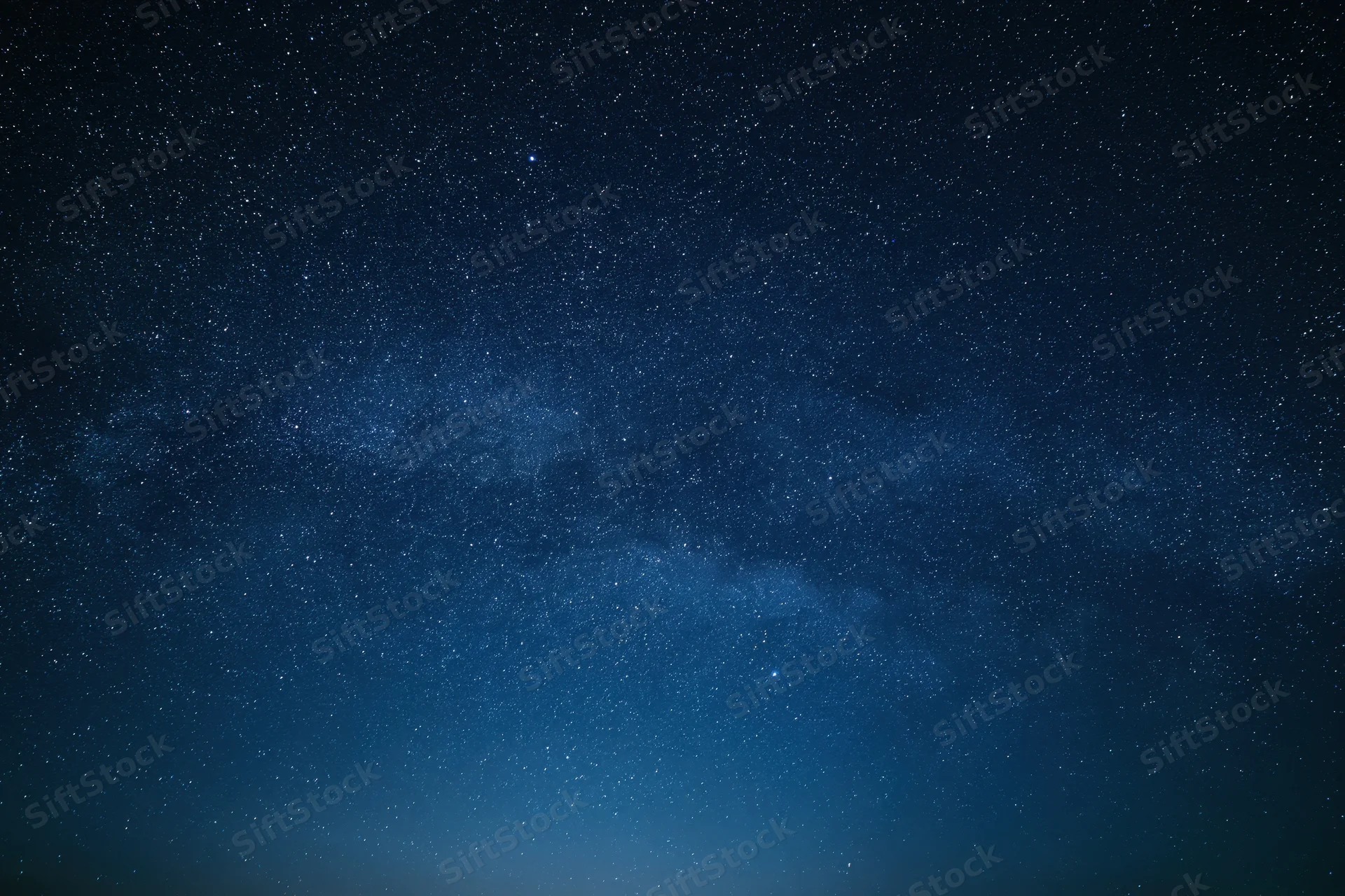 Dark night sky filled with countless stars and the milky way band across the frame