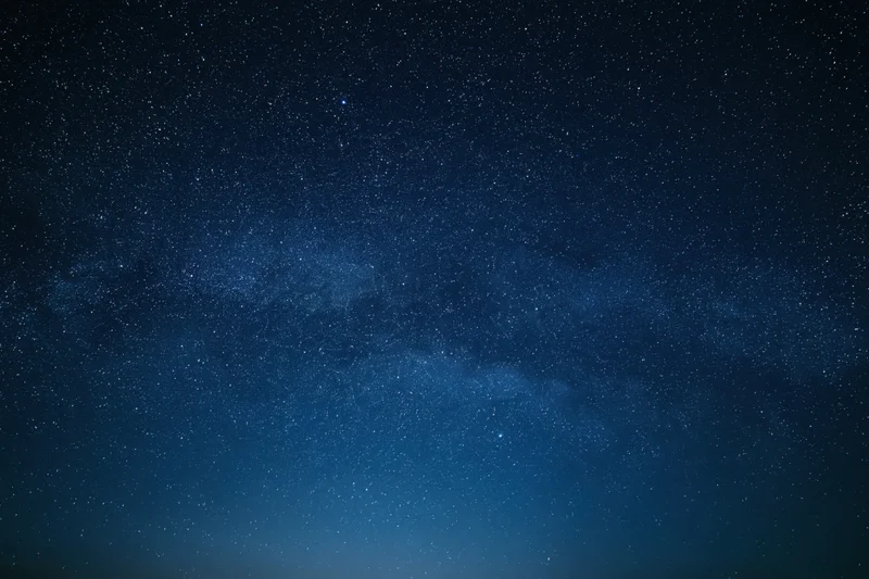 Dark night sky filled with countless stars and the milky way band across the frame