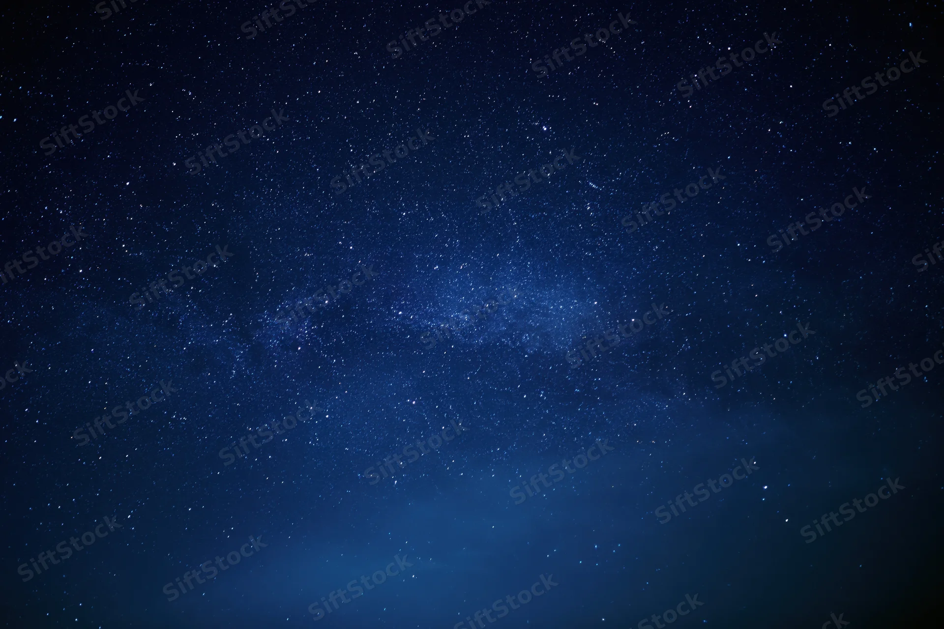 Night sky filled with stars and the milky way visible across the dark blue expanse