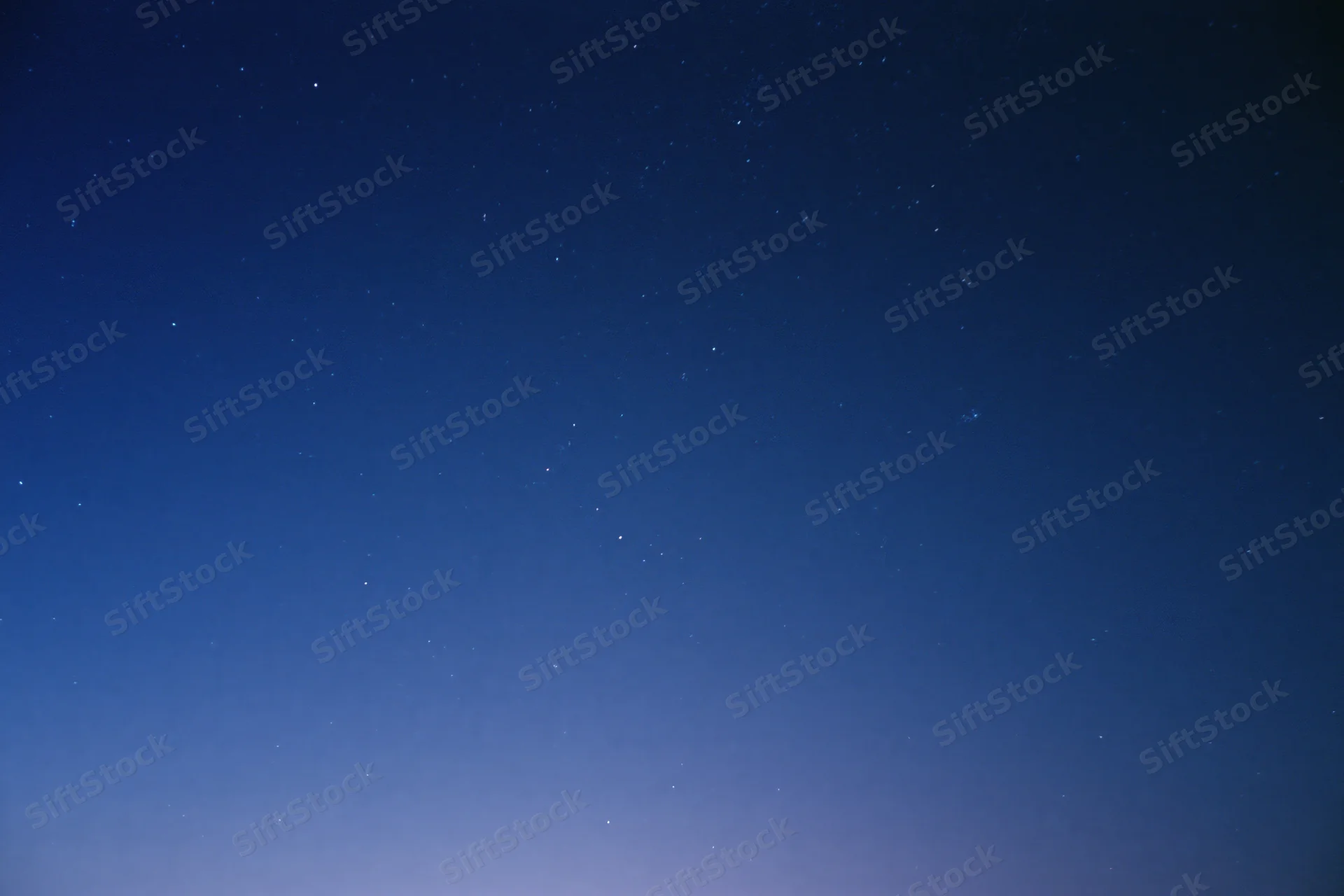 Clear night sky filled with scattered faint stars, no horizon visible